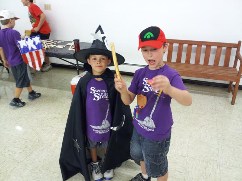 Two Wizards, one in full battle dress, the other using his wand to conjure a plastic fish from the Trading Post. Two Wizards, one in full battle dress, the other using his wand to conjure a plastic fish from the Trading Post.